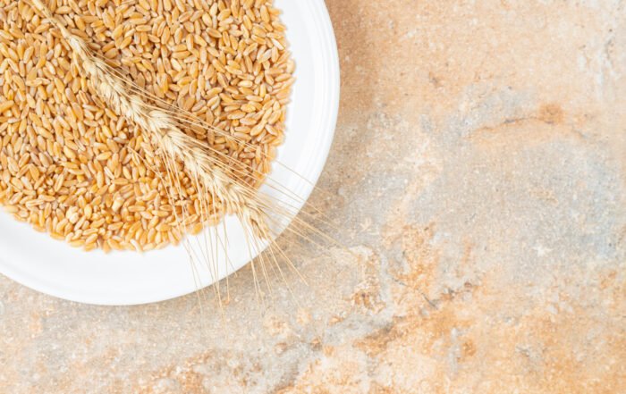 Grain And Wheat Ear On A Plate , On The Marble Background